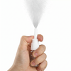 Hand pressing the nasal spray pump showing fine mist output